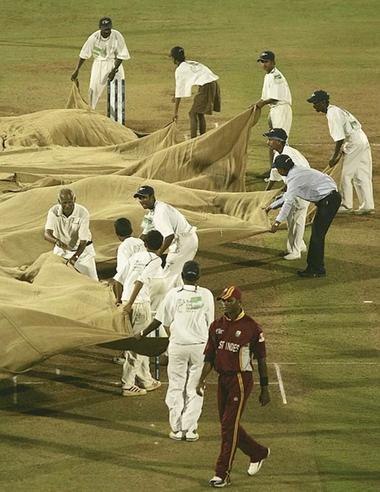 Groundstaff at the Brabourne Stadium cover the pitch during the dinner break, West Indies v Australia, Champions Trophy final, Mumbai, November 5, 2006