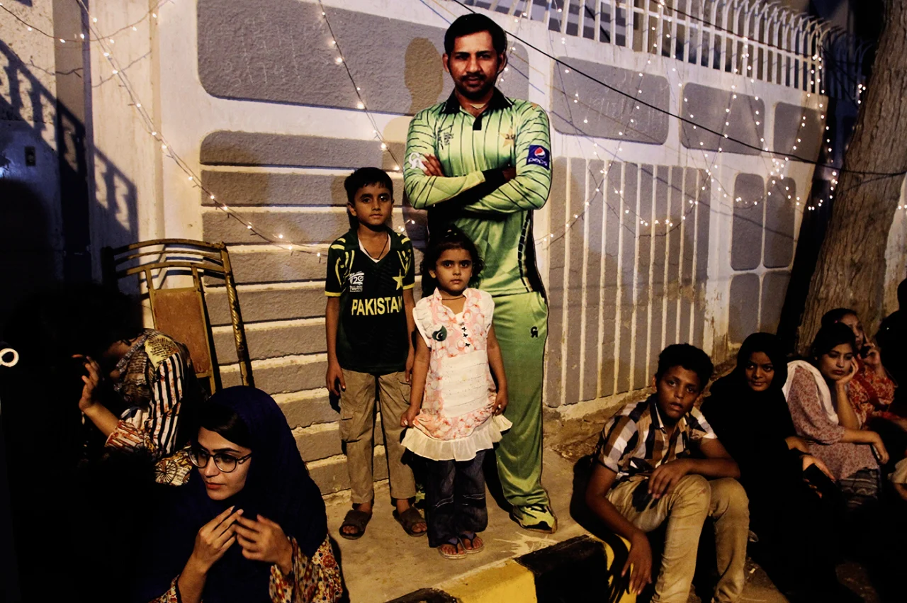 Two kids pose with a cutout of Sarfraz Ahmed, Karachi, June 20, 2017