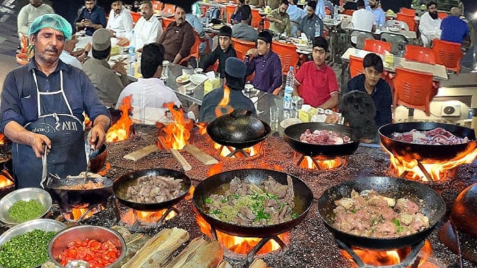 A close-up shot of a Lahori food street with dishes like Nihari or Biryani on display.