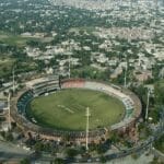 A creative shot showing the stadium with Lahore’s skyline in the background, blending cricket and culture