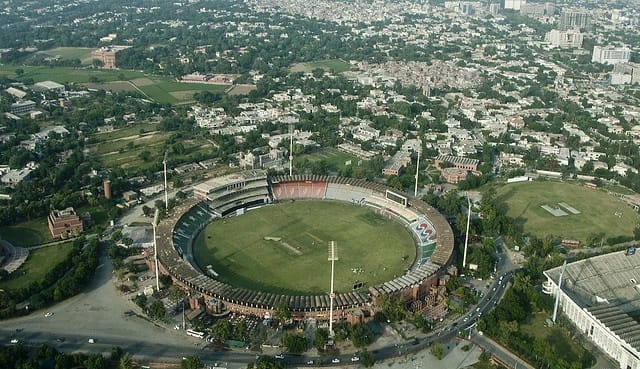 A creative shot showing the stadium with Lahore’s skyline in the background, blending cricket and culture