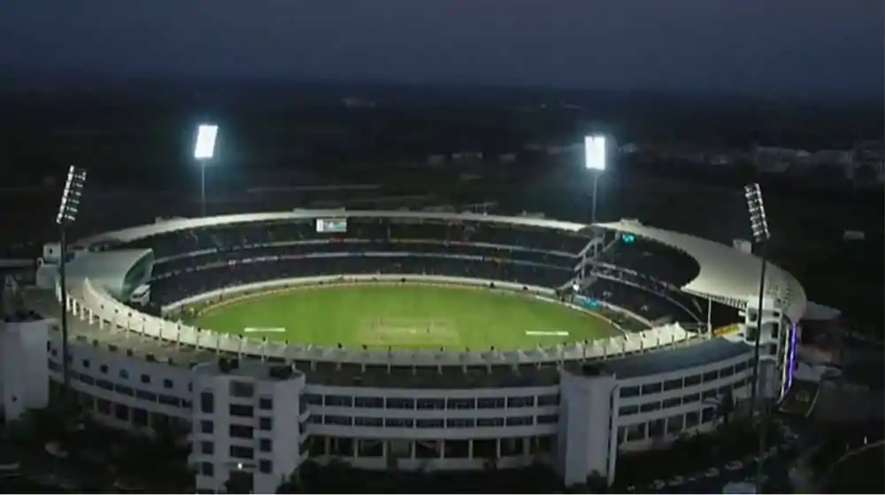 A current image of Gaddafi Stadium, highlighting its renovated seating and floodlights.