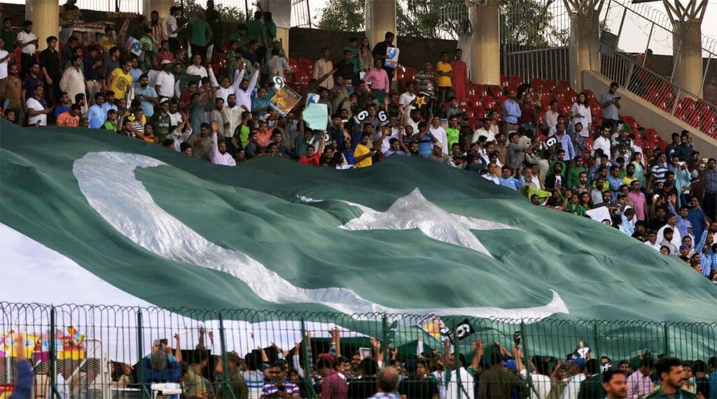 A historical image of Gaddafi Stadium packed with fans during a major match