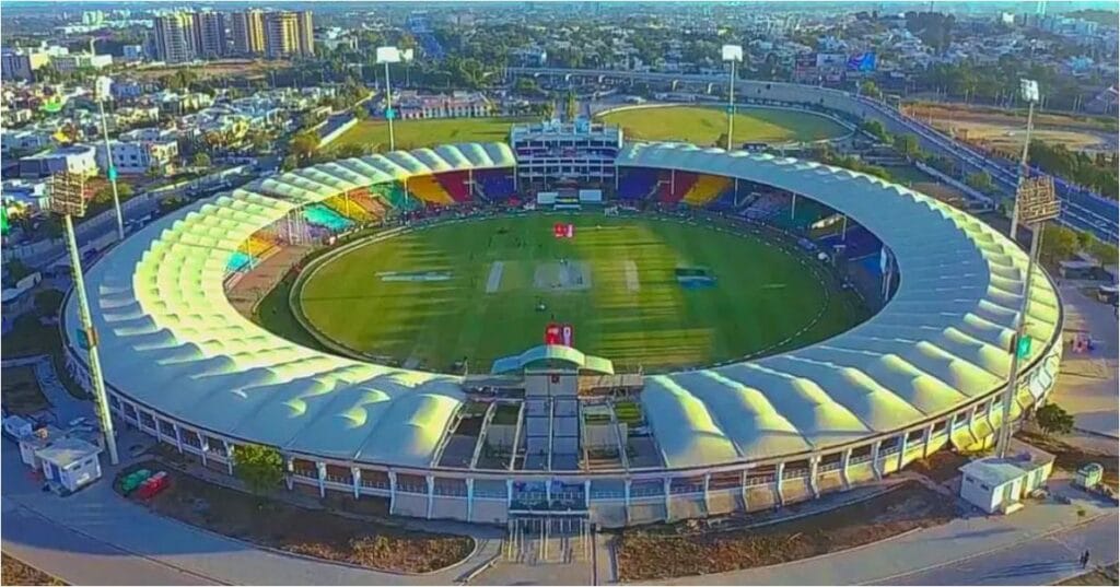 A vibrant, wide-angle shot of Karachi’s skyline or a cricket match in progress at the National Stadium.